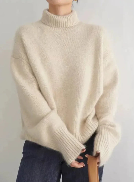 Women's soft turtleneck knit sweater with ribbed cuffs and relaxed fit