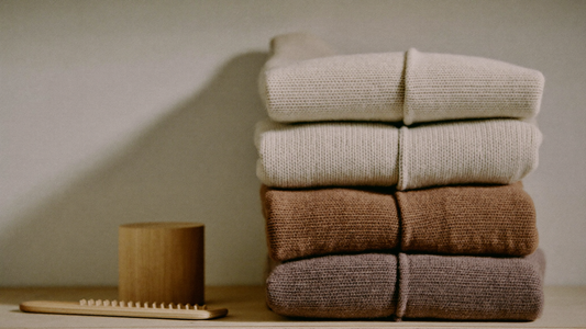 Folded wool jumpers on a shelf