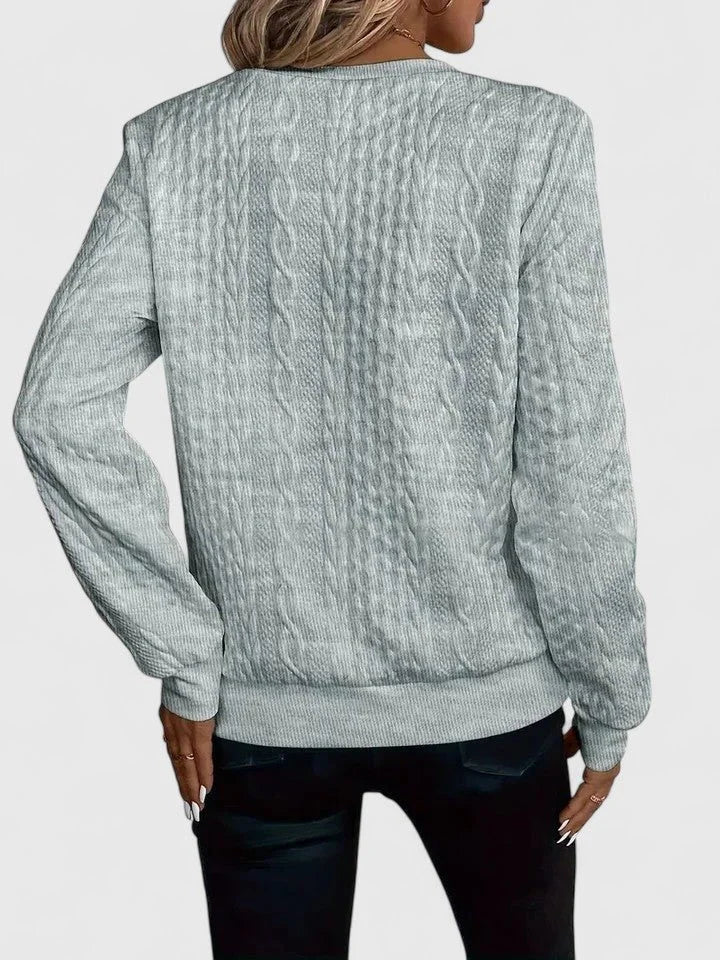 Women's cable knit pullover sweater with V-neckline detail