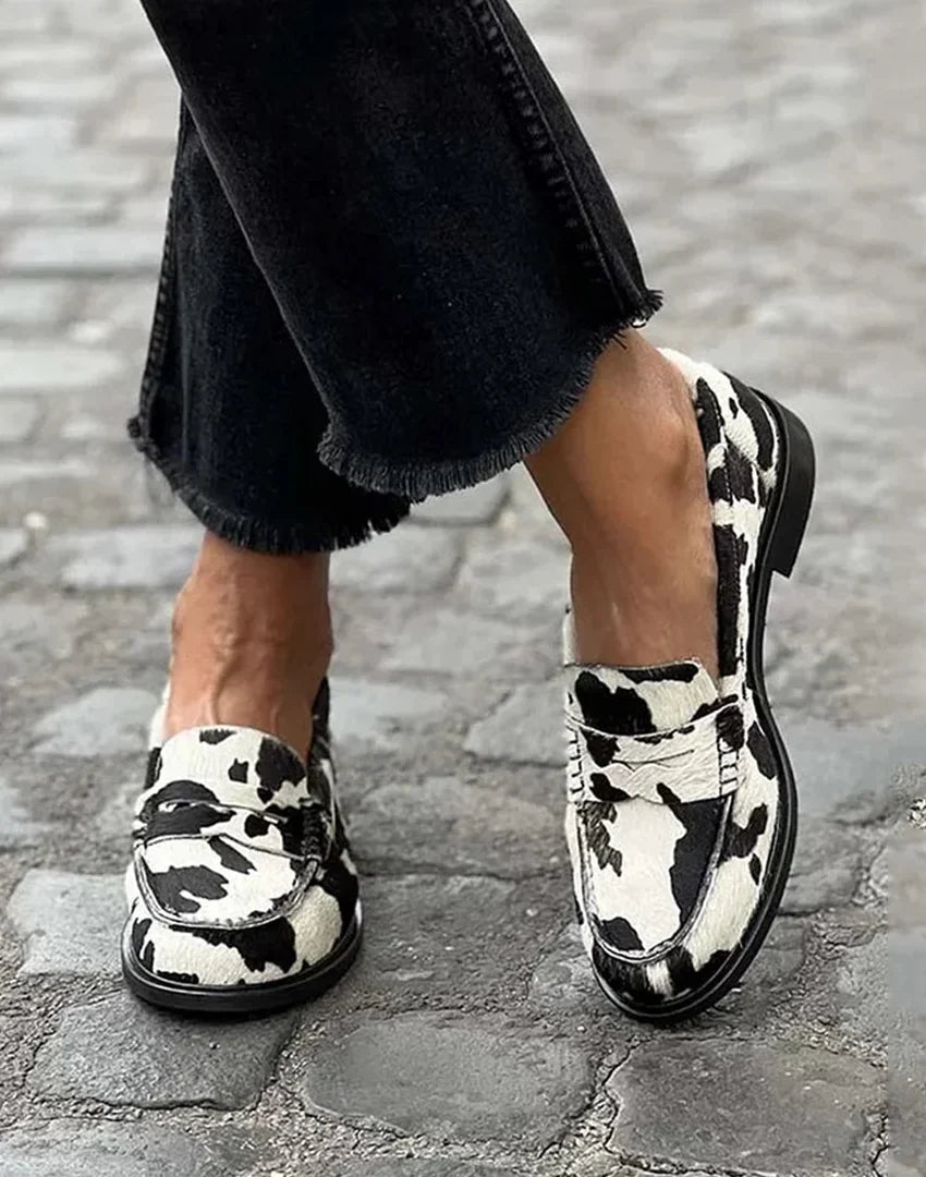 Women's cow-print penny loafers with a slip-on flat-heel style – Black/White