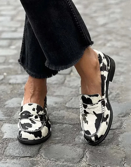 Women's cow-print penny loafers with a slip-on flat-heel style – Black/White