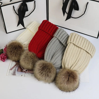 Women's cozy knit sweater-style beanie with faux fur pom
