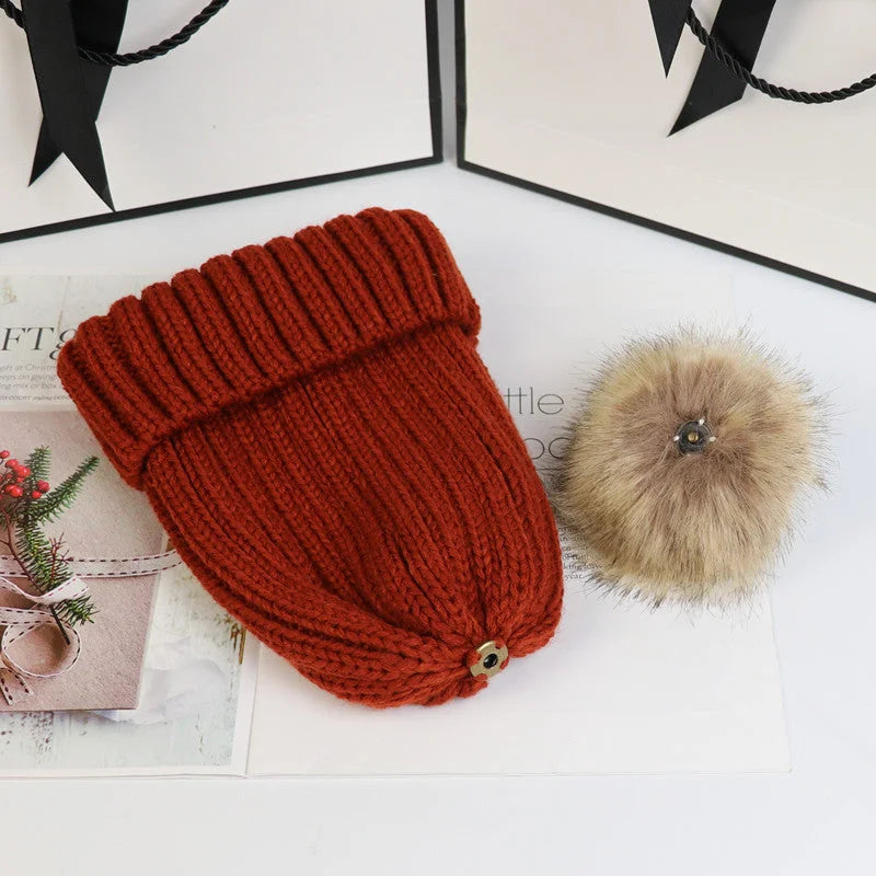 Women's cozy knit sweater-style beanie with faux fur pom