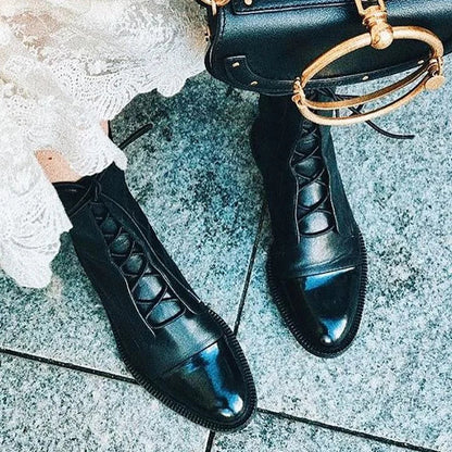 Women's leather heeled pointed-toe boots with lace-up cap-toe design