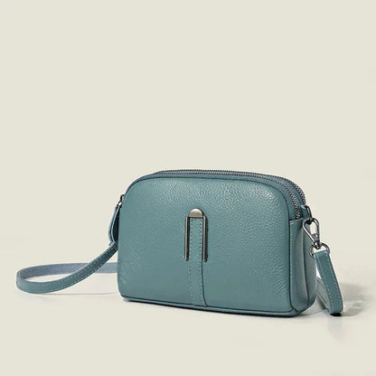 Women's leather shoulder bag with double zip closure and metal accent