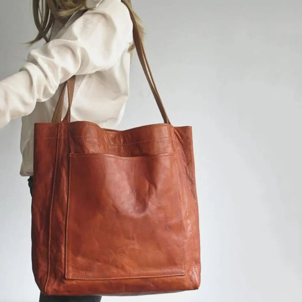 Women's leather tote bag with magnetic snap closure and front patch pocket