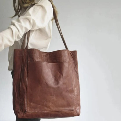 Women's leather tote bag with magnetic snap closure and front patch pocket