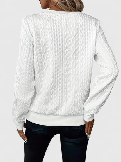Women's cable-knit sweater with half-zip front and long sleeves
