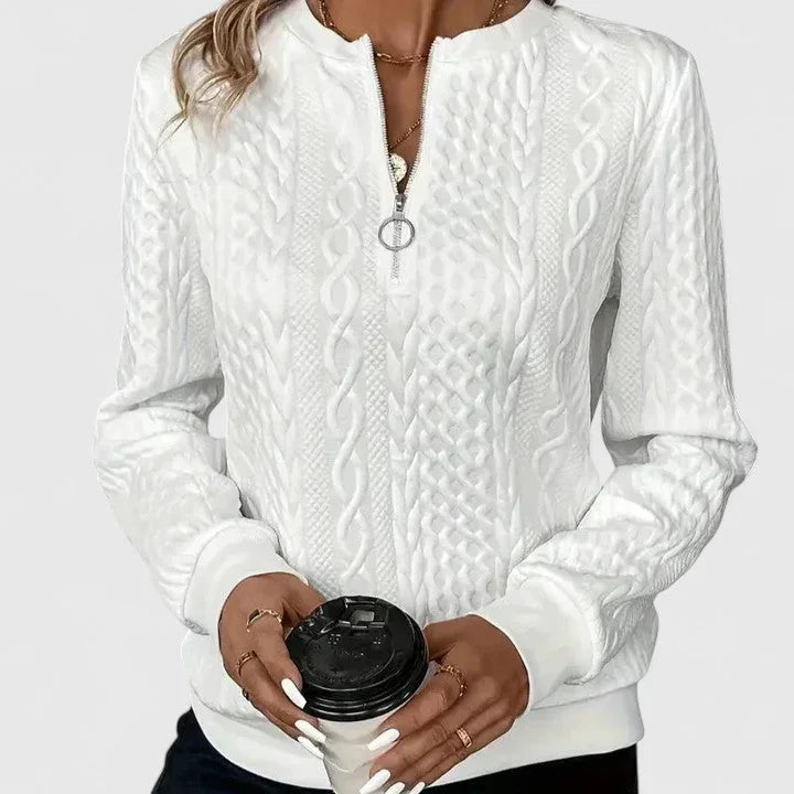 Women's cable-knit sweater with half-zip front and long sleeves