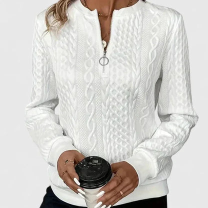 Women's cable-knit sweater with half-zip front and long sleeves