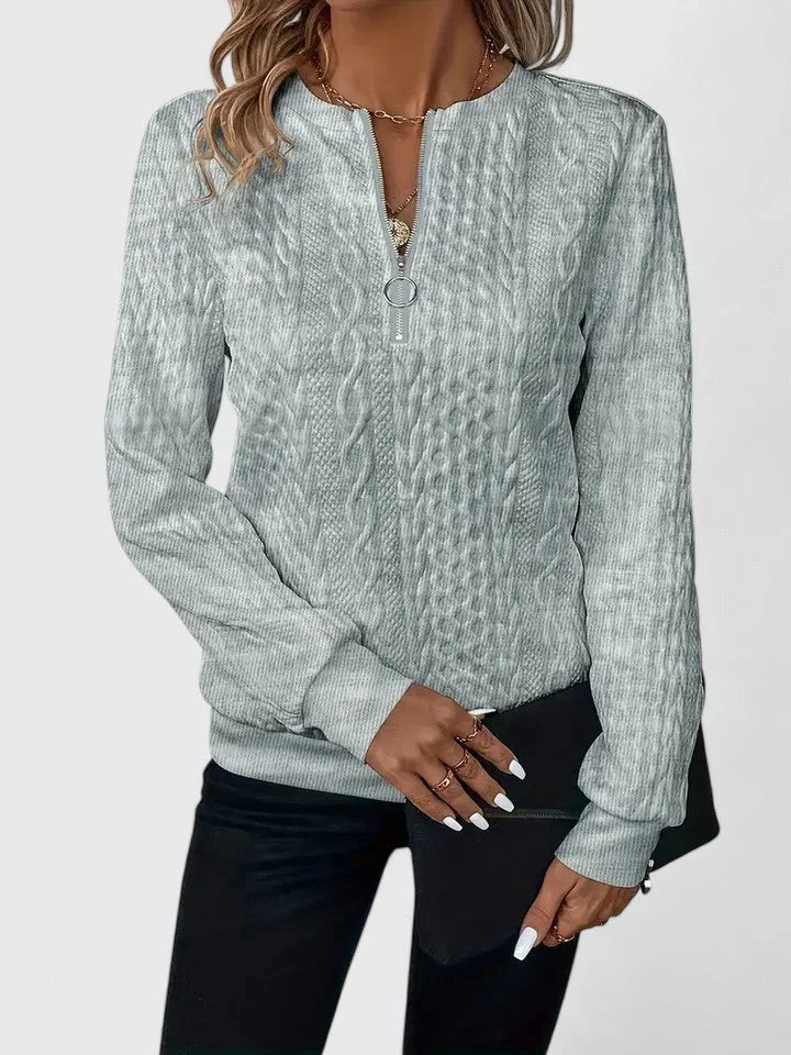 Women's cable-knit sweater with half-zip front and long sleeves