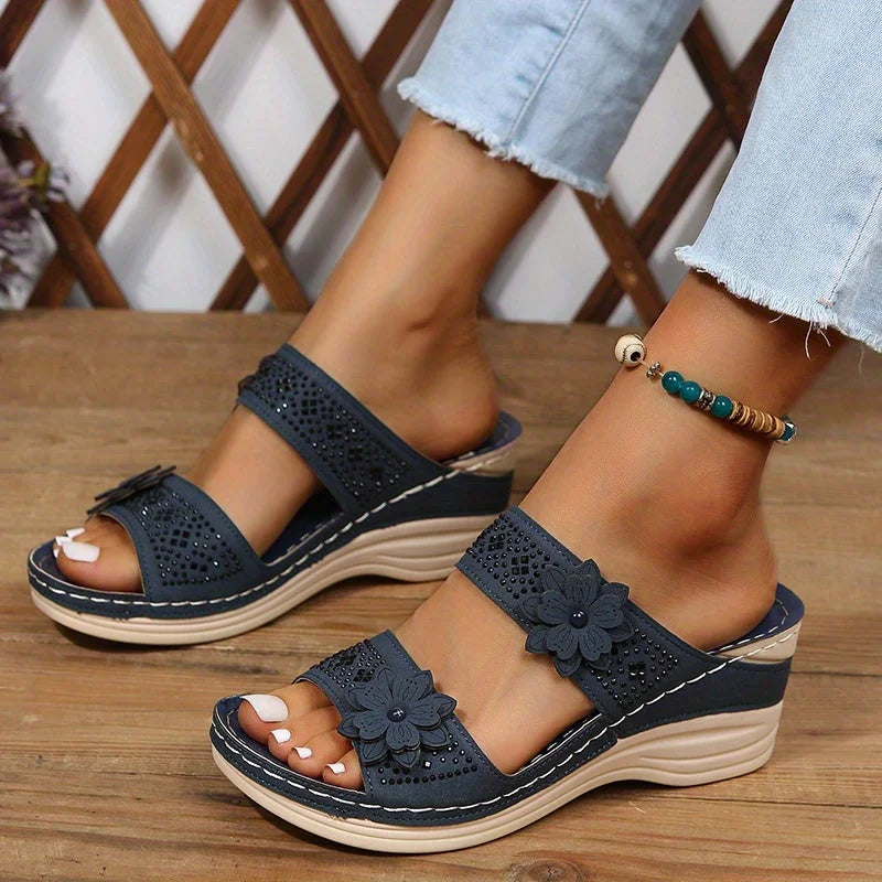 Women's comfort faux suede perforated wedge slides with floral appliqué