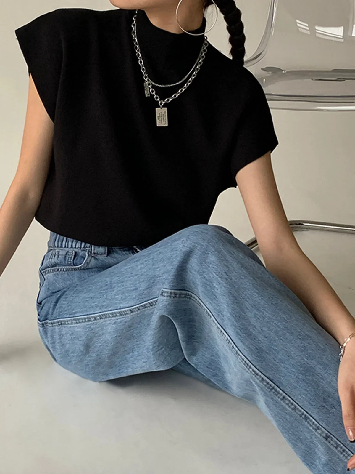 Women's knit padded-shoulder top with mock-neck and cap-sleeves