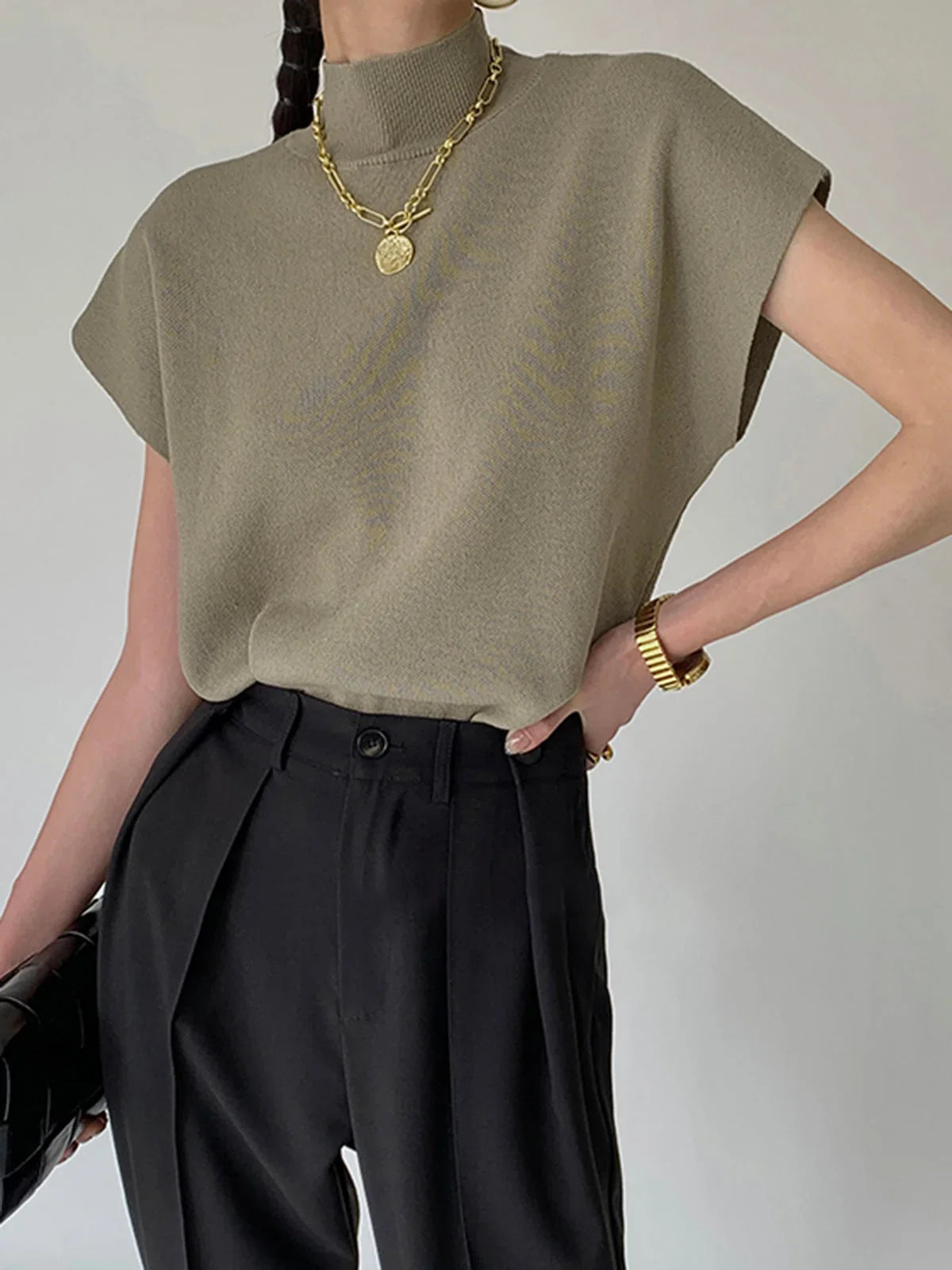 Women's knit padded-shoulder top with mock-neck and cap-sleeves