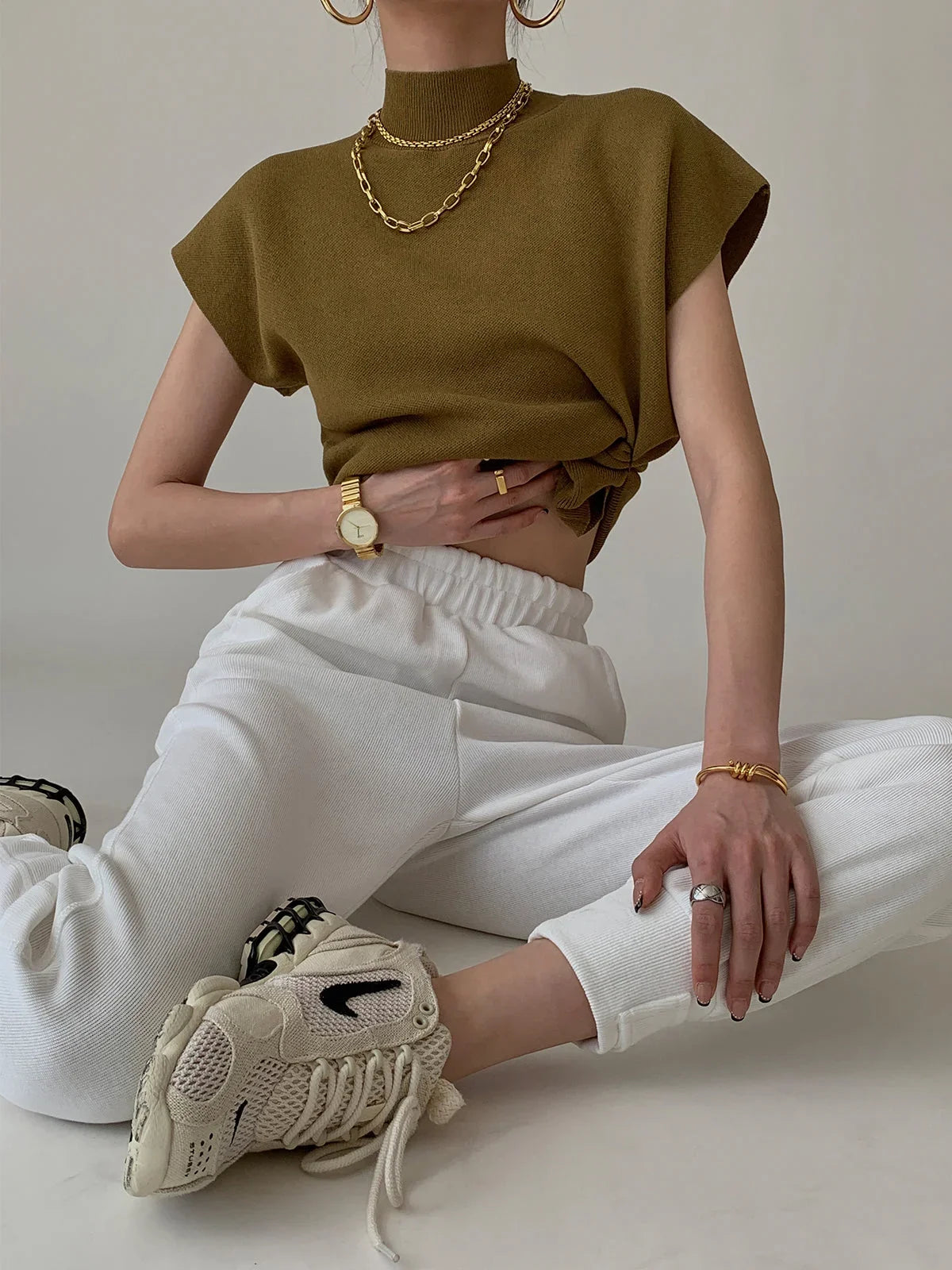 Women's knit padded-shoulder top with mock-neck and cap-sleeves