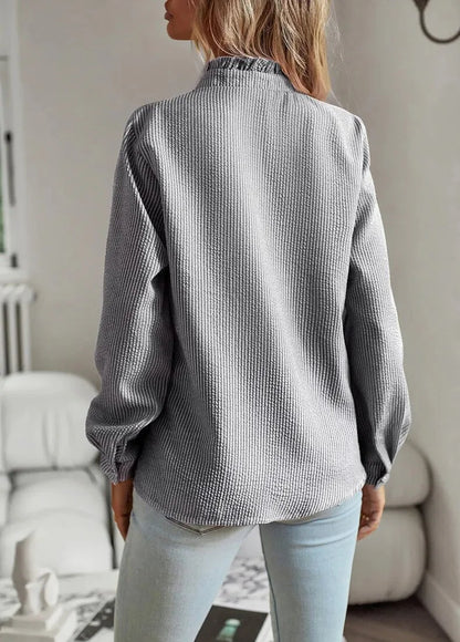 Women's pale textured striped blouse with long sleeves and ruffled stand-collar