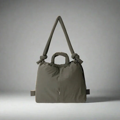 Women's quilted puffer tote bag with drawstring sides and knot-detail strap