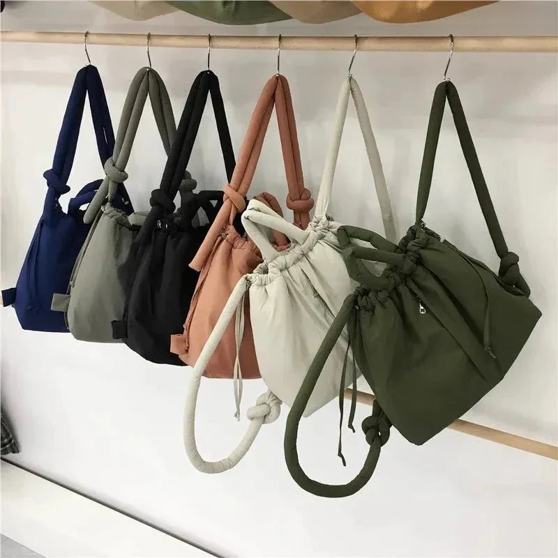 Women's quilted puffer tote bag with drawstring sides and knot-detail strap