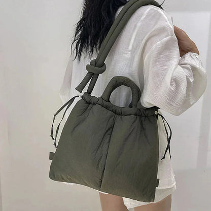 Women's quilted puffer tote bag with drawstring sides and knot-detail strap