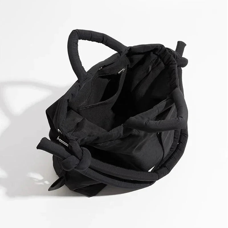 Women's quilted puffer tote bag with drawstring sides and knot-detail strap