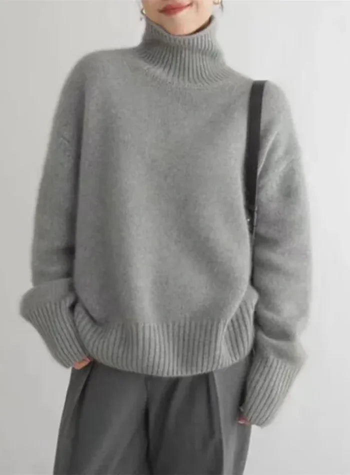 Women's soft turtleneck knit sweater with ribbed cuffs and relaxed fit