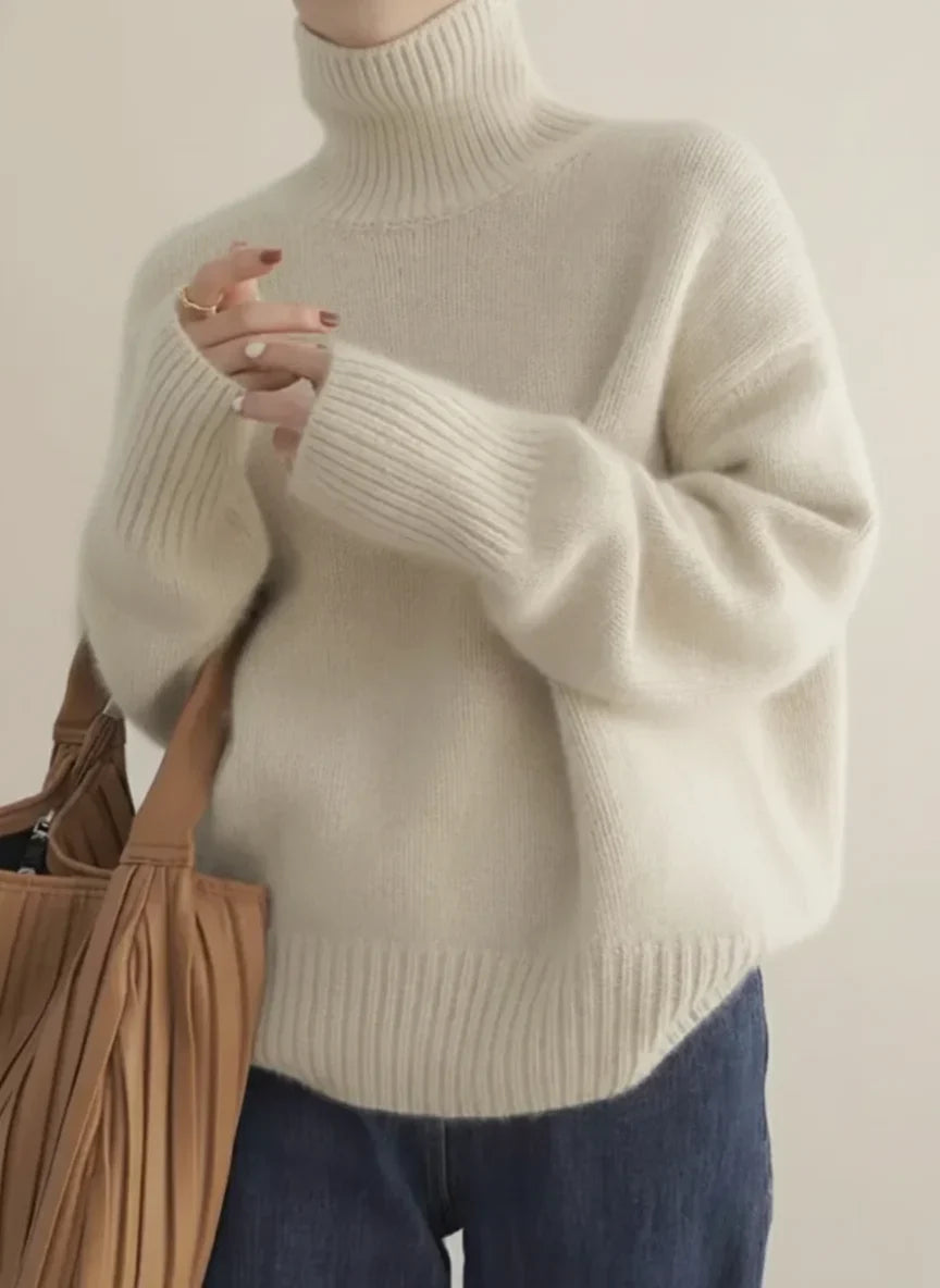 Women's soft turtleneck knit sweater with ribbed cuffs and relaxed fit