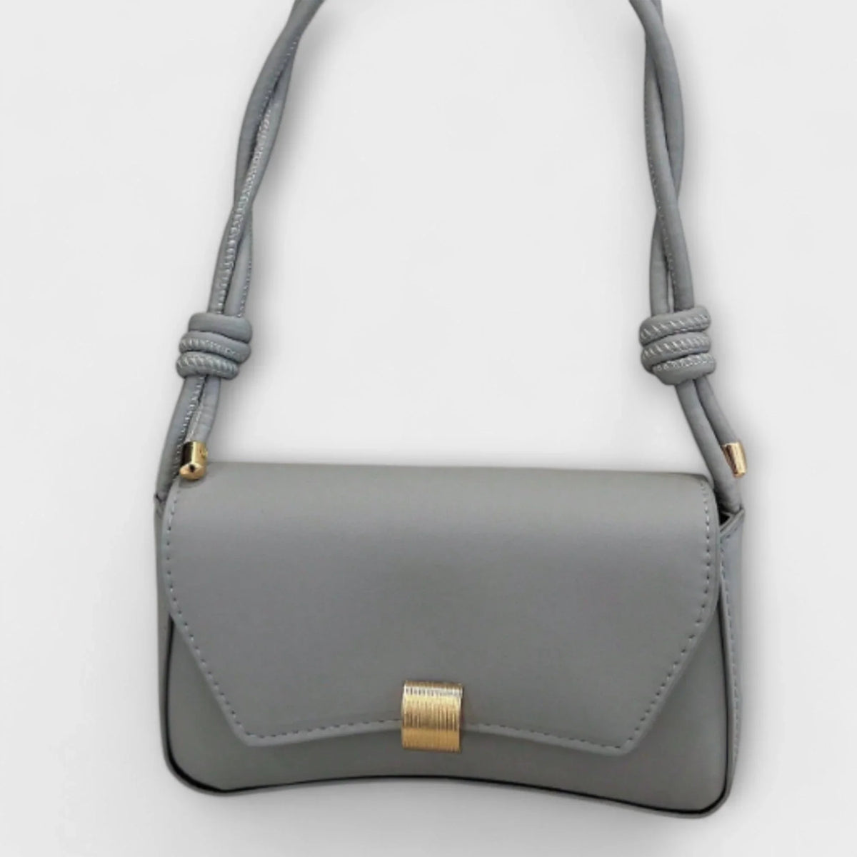 Women's solid color faux leather shoulder bag with flap closure and knotted strap