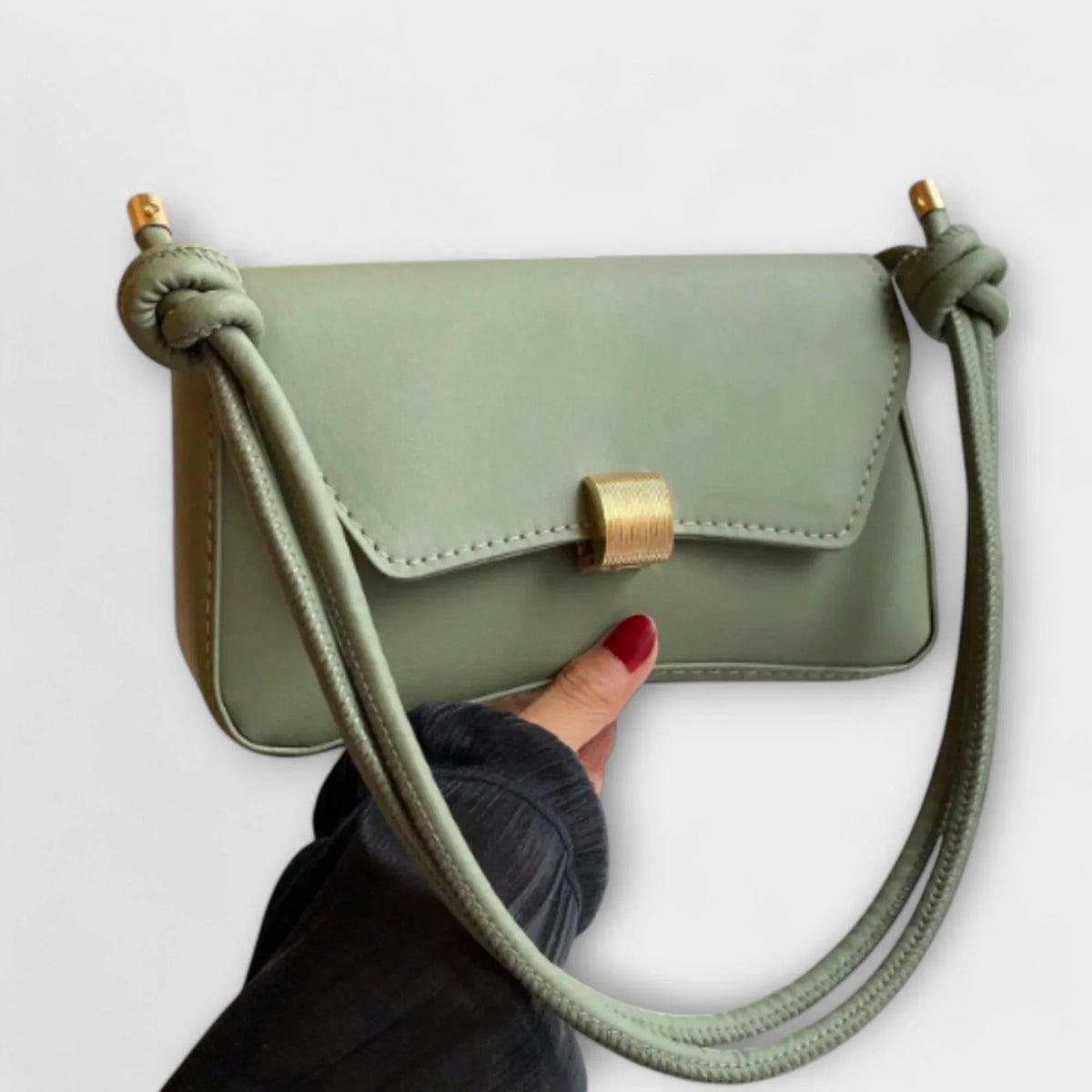 Women's solid color faux leather shoulder bag with flap closure and knotted strap
