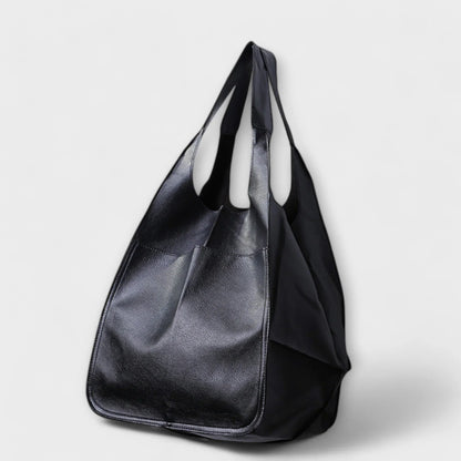 Women's spacious faux leather tote bag with two exterior slip pockets