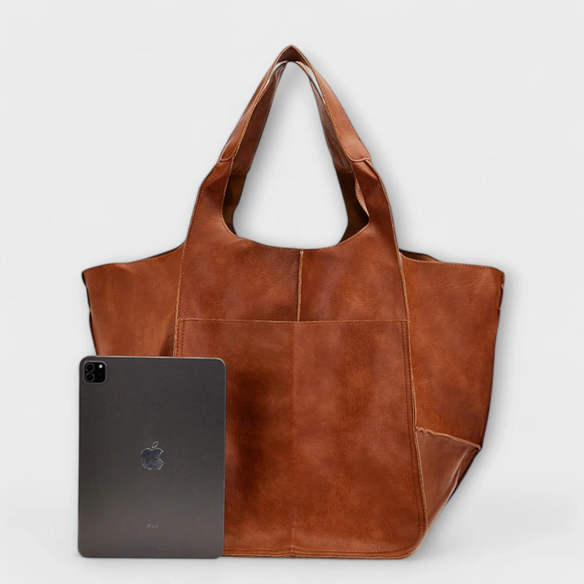 Women's spacious faux leather tote bag with two exterior slip pockets