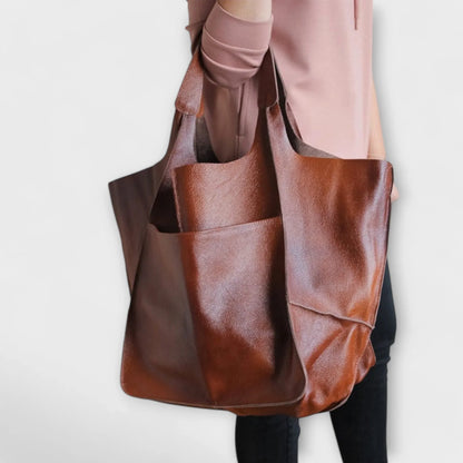 Women's spacious faux leather tote bag with two exterior slip pockets