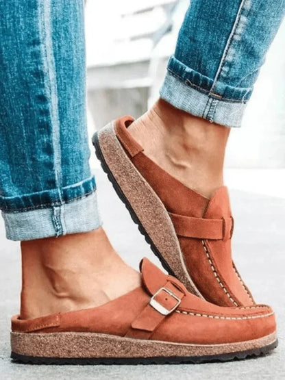 Women's suede comfort clogs with buckled strap and contrast stitching