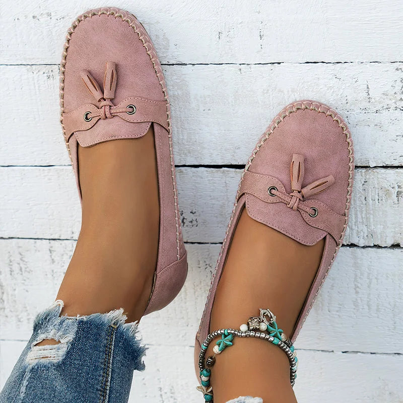 Women's suede slip-on loafers with front tassels and moccasin stitching