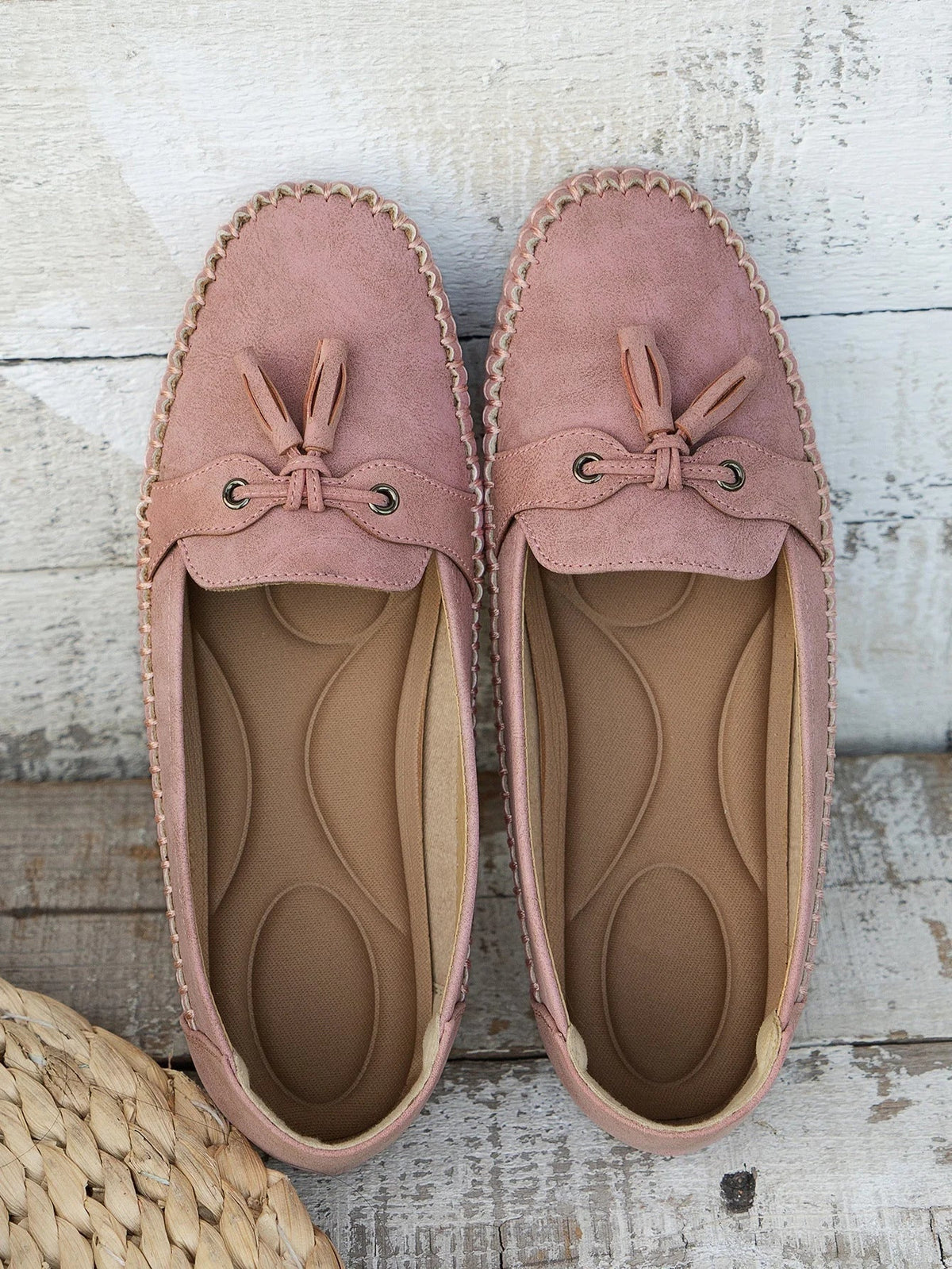 Women's suede slip-on loafers with front tassels and moccasin stitching