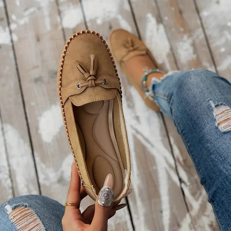 Women's suede slip-on loafers with front tassels and moccasin stitching