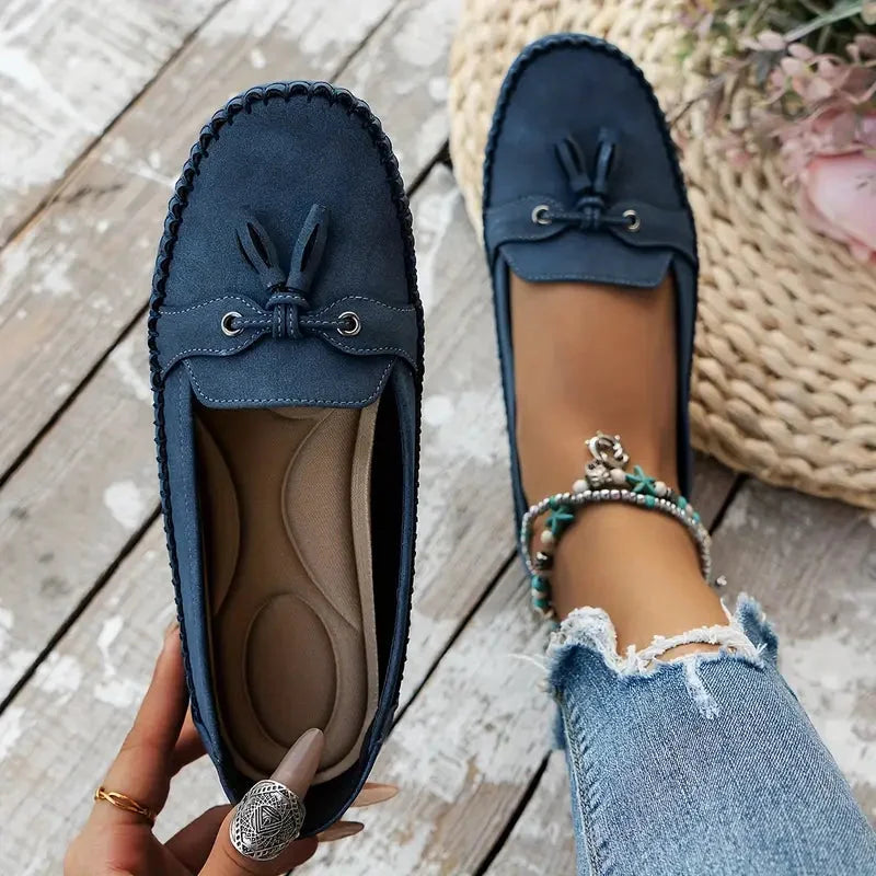 Women's suede slip-on loafers with front tassels and moccasin stitching
