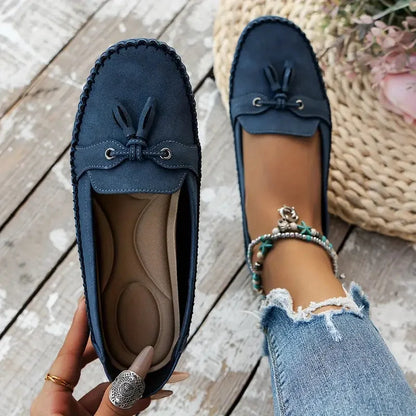 Women's suede slip-on loafers with front tassels and moccasin stitching