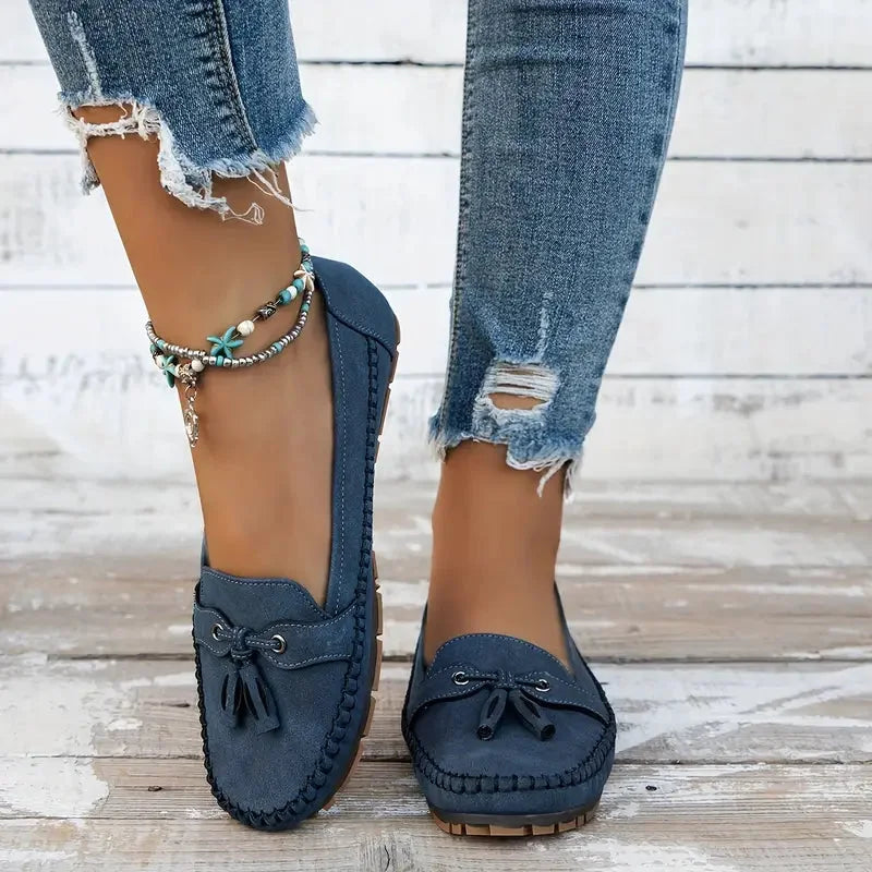 Women's suede slip-on loafers with front tassels and moccasin stitching