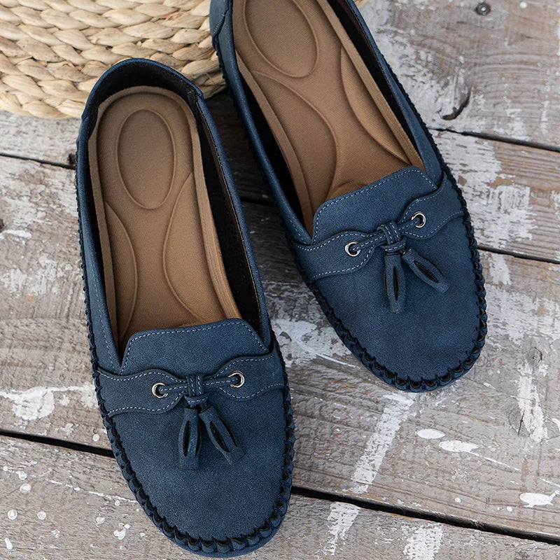 Women's suede slip-on loafers with front tassels and moccasin stitching