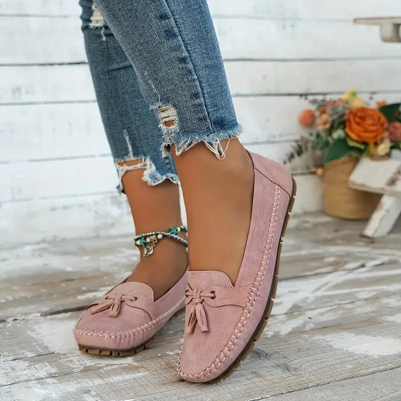 Women's suede slip-on loafers with front tassels and moccasin stitching