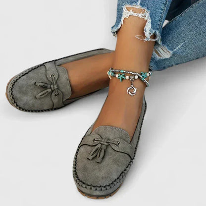Women's suede slip-on moccasin flat loafers with tasseled bow detail