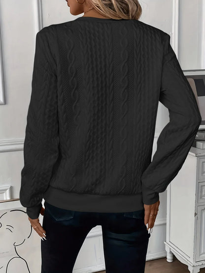 Women's textured knit sweater with quarter-zip closure and long sleeves