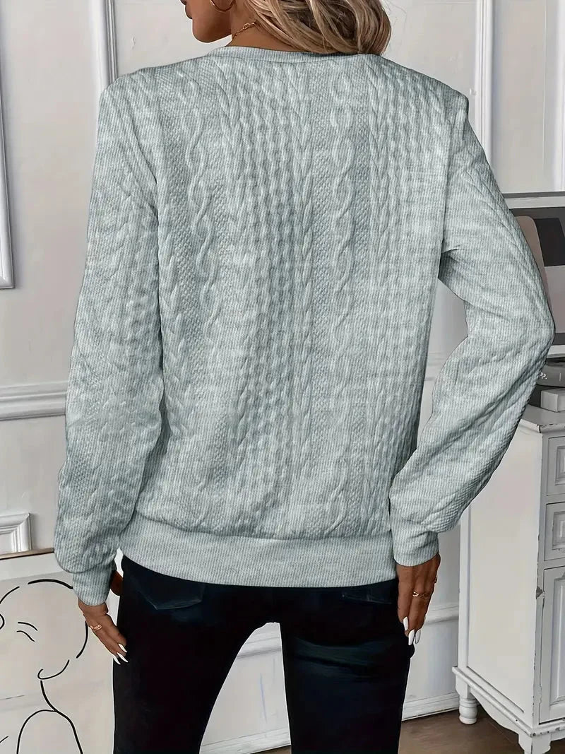 Women's textured knit sweater with quarter-zip closure and long sleeves
