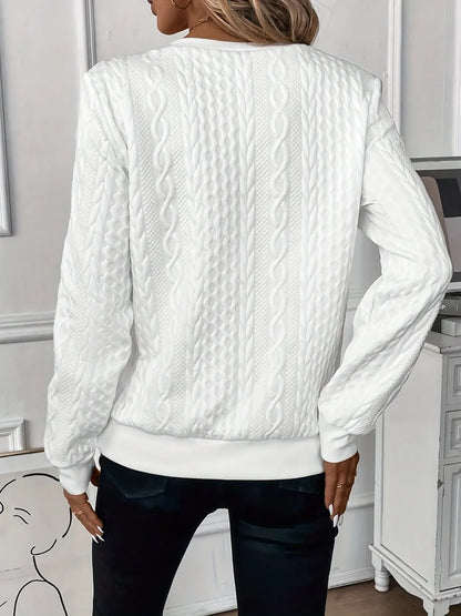 Women's textured knit sweater with quarter-zip closure and long sleeves
