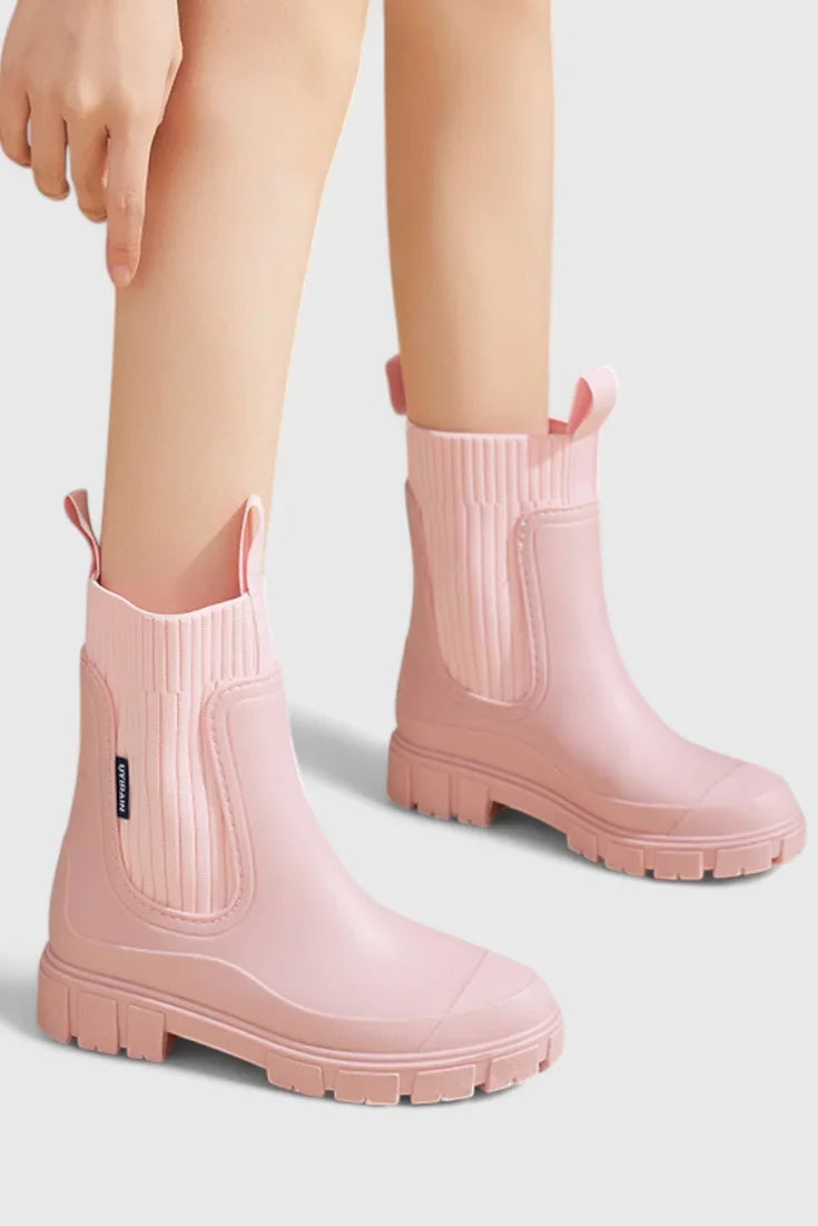 Women's waterproof rubber chelsea boots with ribbed knit cuffs and lug sole