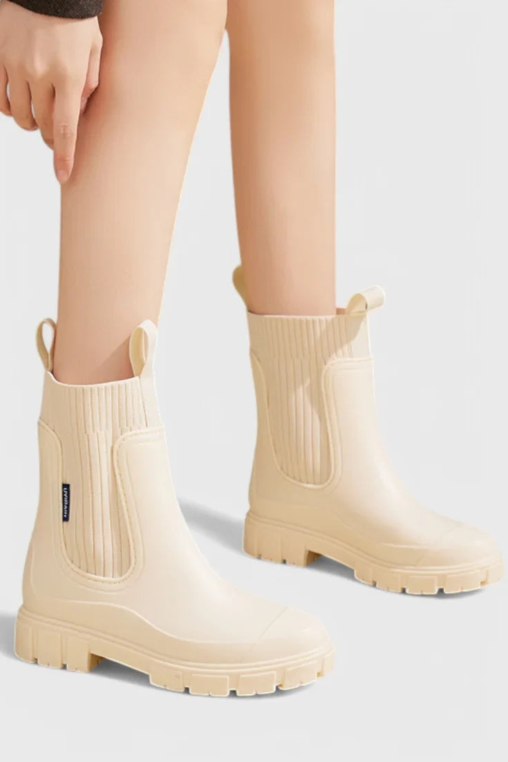 Women's waterproof rubber chelsea boots with ribbed knit cuffs and lug sole