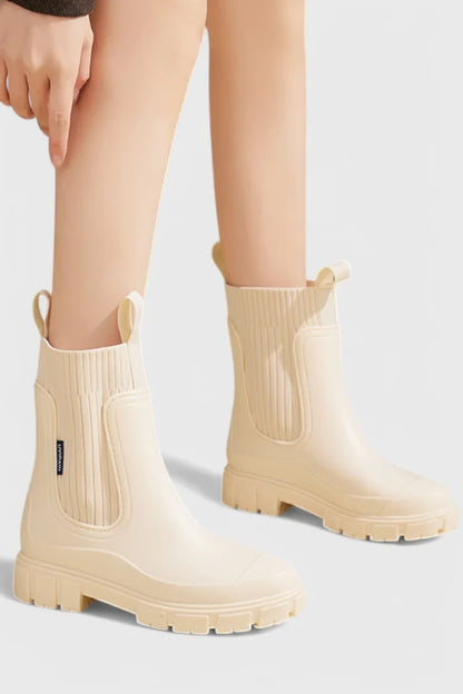 Women's waterproof rubber chelsea boots with ribbed knit cuffs and lug sole