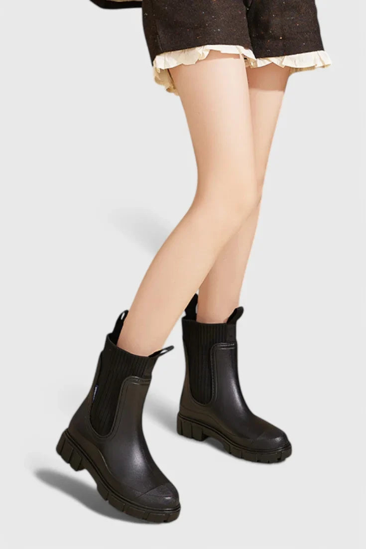 Women's waterproof rubber chelsea boots with ribbed knit cuffs and lug sole