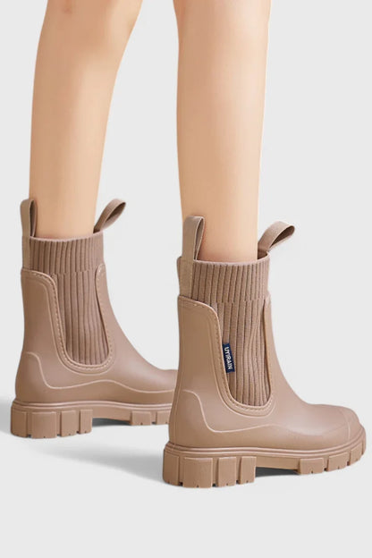 Women's waterproof rubber chelsea boots with ribbed knit cuffs and lug sole
